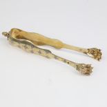 A pair of 19th century French silver-gilt lion paw sugar tongs, bright-cut engraved floral