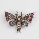 A Victorian unmarked gold ruby sapphire pearl and diamond figural butterfly brooch, set with round-