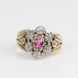 An Antique unmarked gold ruby and diamond cluster flowerhead ring, set with oval mixed-cut ruby