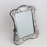 An Elizabeth II Art Nouveau style silver-fronted dressing table strut mirror, relief embossed
