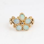 An 18ct gold cabochon opal and diamond cluster flowerhead ring, pierced and engraved scrollwork