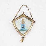 A Victorian unmarked yellow metal mourning pendant, shield form with bevel-glass panels and