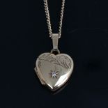 A late 20th century 9ct gold diamond set heart photo locket pendant necklace, on 9ct flat trace curb