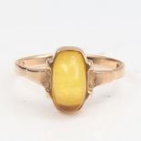 A Continental 14ct gold cabochon yellow stone dress ring, setting height 11.3mm, size P, 2.5g No
