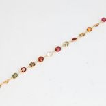 A modern handmade 14ct gold vari-hue sapphire bracelet, set with oval mixed-cut sapphires,