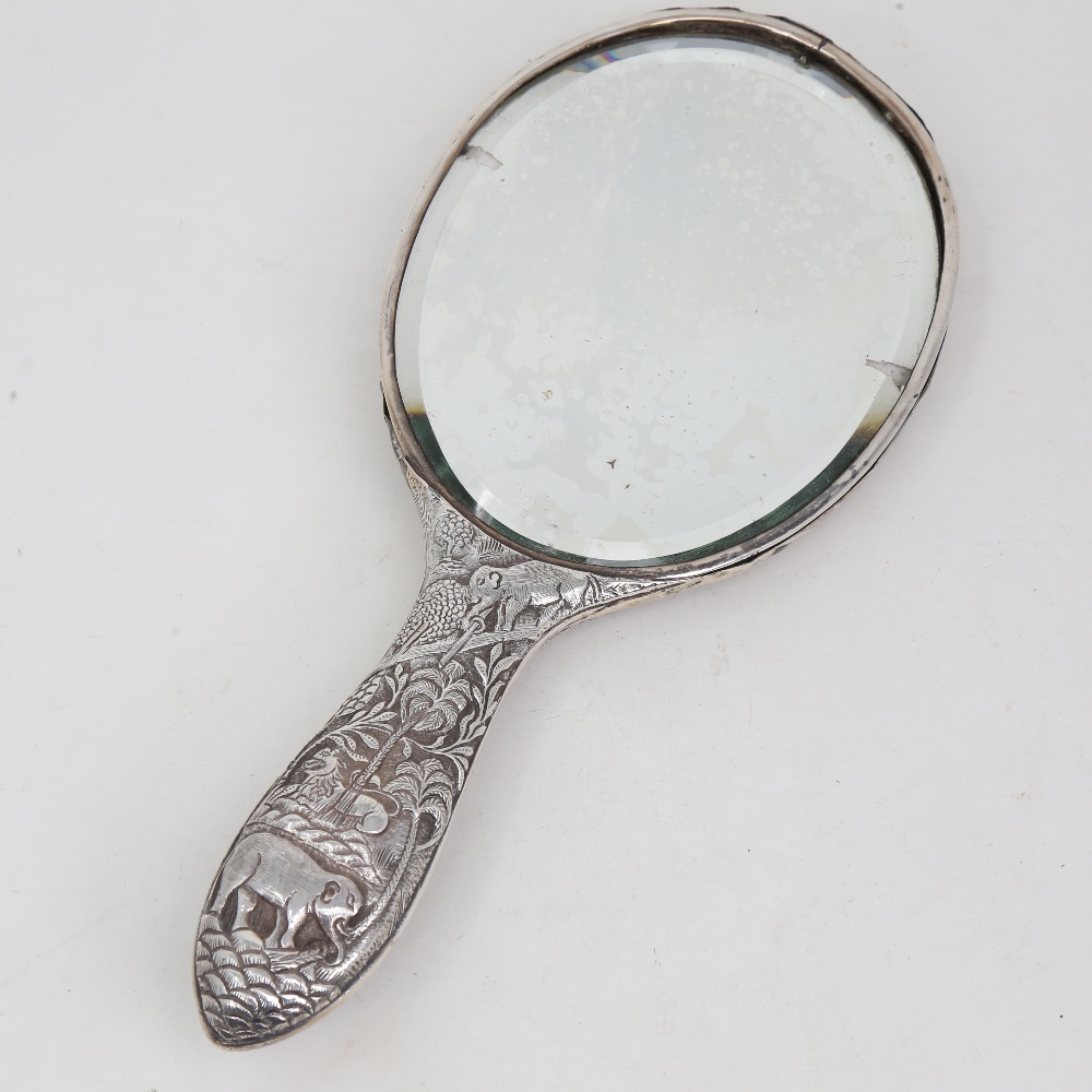 An unmarked Indian silver dressing table hand mirror, allover relief embossed animal and jungle - Image 3 of 5