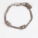 An Antique French silver Albertina watch chain bracelet, with slides and tassel, overall length