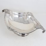A large George V silver 2-handled table centre fruit bowl, oval form with cast scrolled acanthus