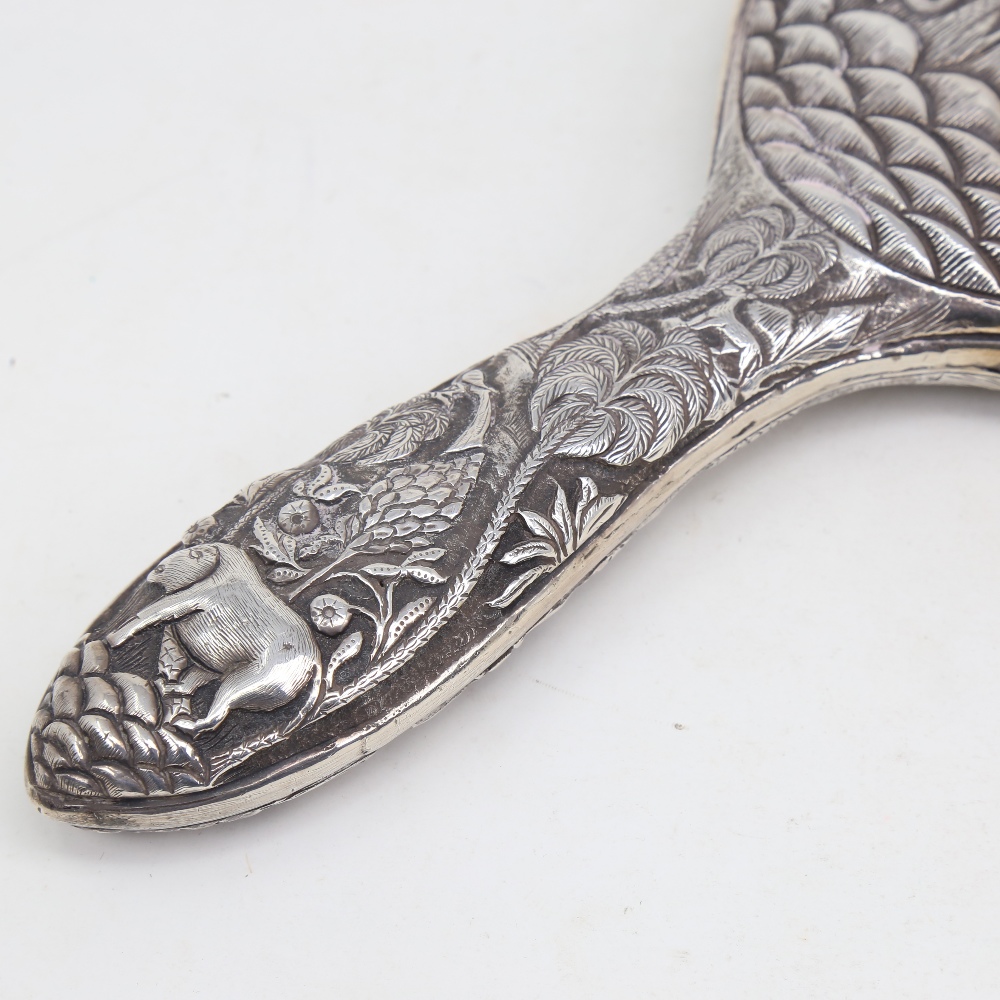 An unmarked Indian silver dressing table hand mirror, allover relief embossed animal and jungle - Image 5 of 5