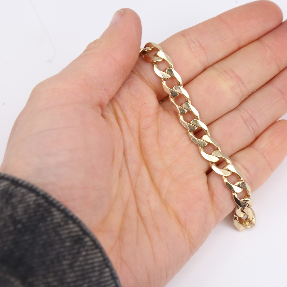 A late 20th century 9ct gold flat curb link bracelet, bracelet length 22cm, 18.9g No damage or - Image 5 of 5