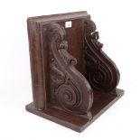 A large carved and stained oak wall bracket, with applied match striker, W36cm, D35cm, H25cm