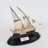 A Continental sterling silver model ship, stamped with Maltese Cross, on ebonised base, overall