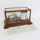 An Antique brass barograph, in glazed oak case, with spare sheets, by Short & Mason London, length