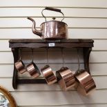 A Victorian oval copper kettle, height 37cm, and a graduated set of 5 copper saucepans, with rack