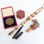 1902 Coronation medallion, carved bead necklace, novelty articulated elephant bottle stop, lacquer