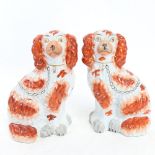 A pair of Edwardian Staffordshire Spaniels, height 24.5cm