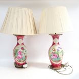 A pair of Vintage Continental porcelain table lamps, on metal plinths, with painted floral