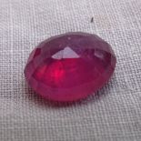 A 7.68ct unmounted oval mixed-cut ruby, dimensions: 12.28mm x 10.64mm x 5.76mm, evidence of
