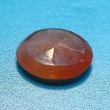 A 1.63ct oval mixed-cut orange sapphire, dimensions: 8.50mm x 7.23mm x 2.40mm, indications of heat