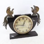 An Art Deco slate and alabaster mantel clock, surmounted by spelter birds, base length 30cm,