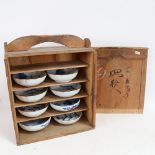 A set of 8 Japanese blue and white pottery bowls, in original hardwood case, with character marks,