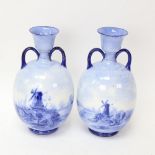 A pair of Doulton Burslem blue and white ceramic vases, Dutch windmill scenes, artist's initials HK,