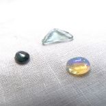 3 unmounted gemstones, comprising 4.46ct triangular step-cut fluorite, 1.29ct oval cabochon opal,