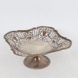 A George V silver pedestal bread basket, pierced Adams style decoration, by John Round & Son Ltd,