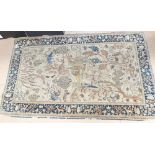 A cream ground wool Persian design rug, with symmetrical border and animal and tree lozenge, 134cm x