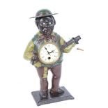 An American painted cast-iron novelty figural clock, modelled as man playing a banjo with moving