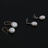 A pair of unmarked white gold pearl and diamond drop earrings, and a similar pair of 9ct gold