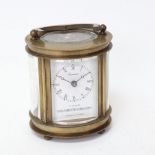 A modern Chinese oval brass-cased carriage clock, curved bevelled-glass exhibition viewing plates,