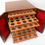 A table-top coin collector's cabinet of drawers, containing various coins, mostly British, including