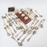 Unpolished garnets, miniature wall clock, and various souvenir teaspoons
