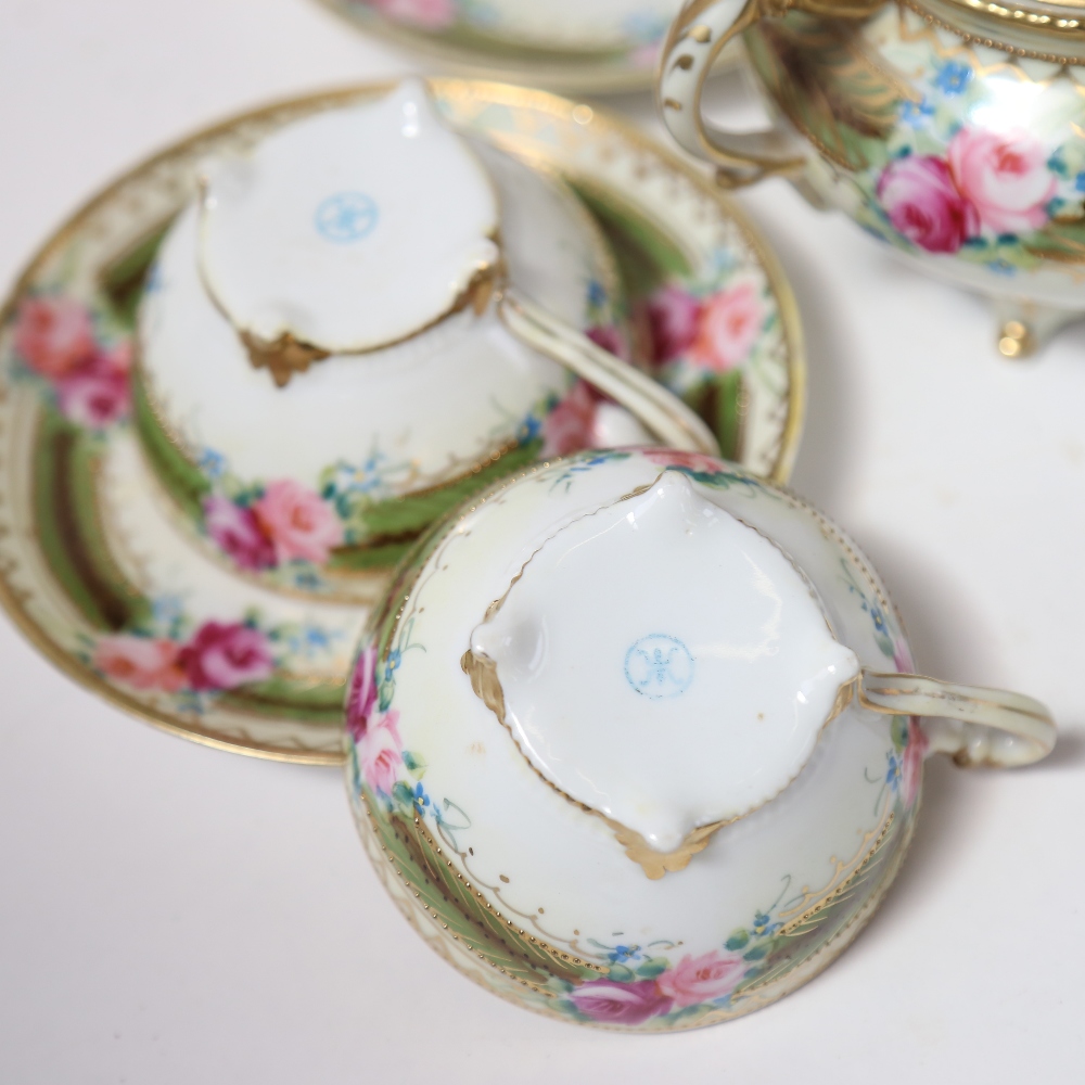 A Japanese porcelain tea service, painted with roses - Image 2 of 2