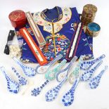 An Oriental embroidered silk tunic, coasters, spoons, chopsticks etc