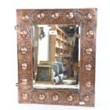 A Vintage bevel-edge mirror, in embossed copper frame, height 50cm