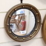 A small gilt framed convex wall mirror, overall diameter 26cm