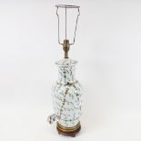 An Oriental porcelain table lamp, on wooden stand, with painted decoration, height 62cm overall
