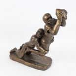 A large modern bronzed composition sculpture, American football tackle, base length 30cm, height