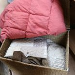 A hamper containing a Marks & Spencer's quilt, and a pink eiderdown