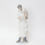 A large Lladro porcelain group, Obstetrician Doctor with new born baby, height 36cm