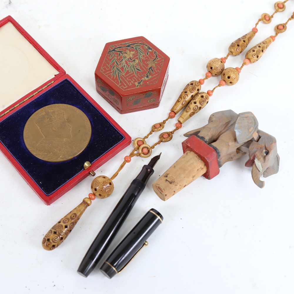 1902 Coronation medallion, carved bead necklace, novelty articulated elephant bottle stop, lacquer - Image 2 of 2