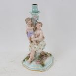 A Continental porcelain candlestick, supported by Classical mother and child figures, 30cm