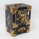 An Oriental black lacquered jewellery cabinet, with engraved brass mounts, and fitted drawers,