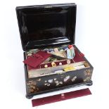 An early 20th century mother-of-pearl inlaid and black lacquered sewing workbox, with original