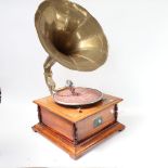 A wind-up gramophone with brass horn and HMV lithographed label.