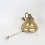 An old brass school bell, with wall mount