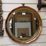 A circular bevel-edge wall mirror, in embossed gilt frame, 46cm