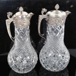 A graduated pair of silver plate-mounted crystal glass Claret jugs, largest height 30cm